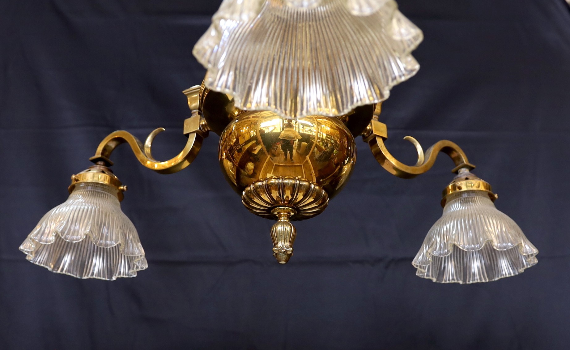 An Edwardian lacquered brass three light chandelier with ribbed glass shades, height 70cm. width 60cm
